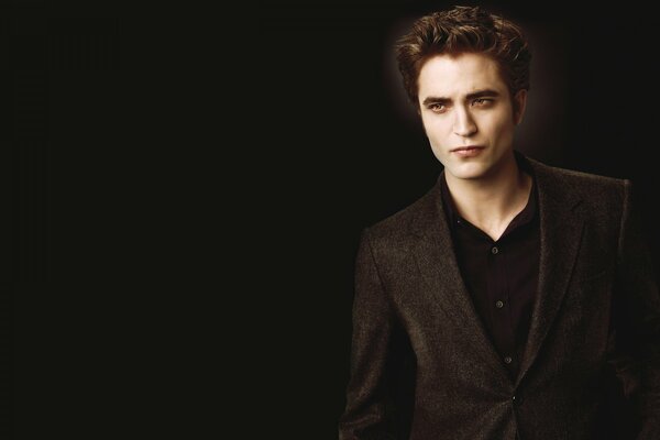 The handsome vampire from the twilight movie. Robert Pattinson on a dark background
