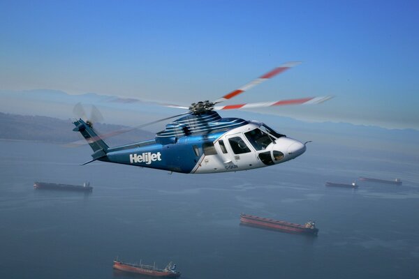 A helicopter flies over the city bay
