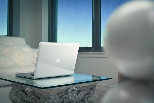 Laptop with a logo on the table