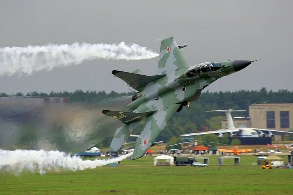 The gray plane performs an aerobatic figure on takeoff