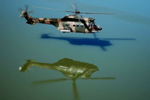 A military helicopter hovered over the water surface