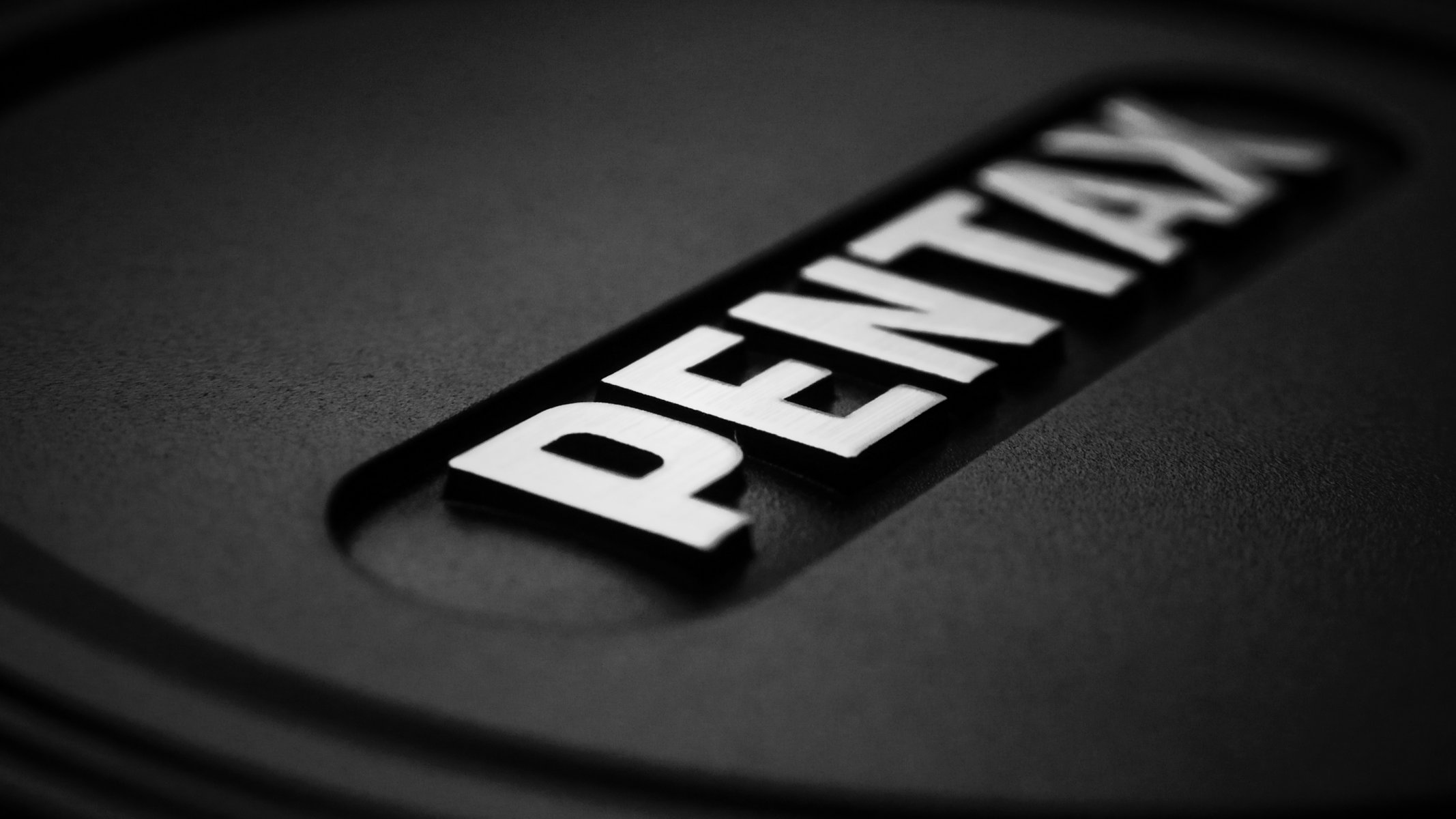 b / w pentax cap the text word brand