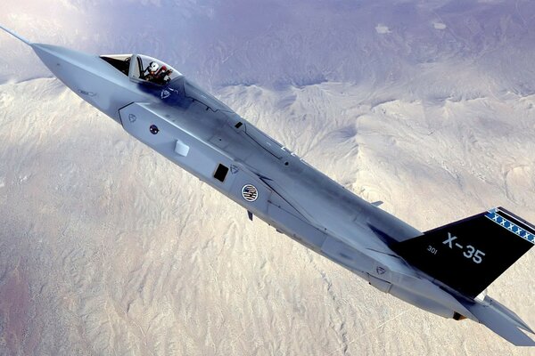 Military aircraft over snowy mountains