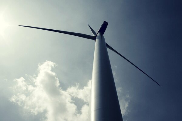 Wind turbine on the background of the sky with clouds