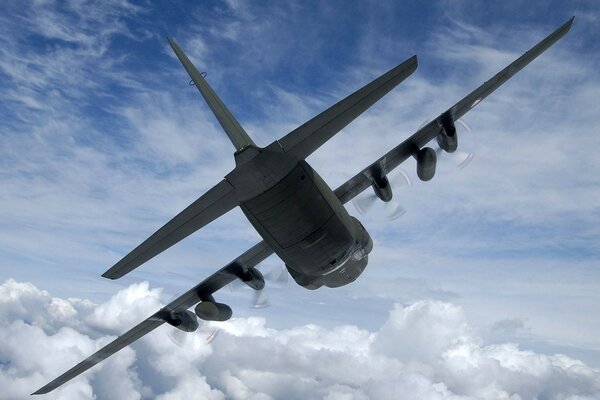 Military bomber aircraft high above the clouds