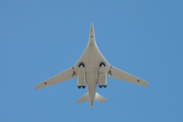 The TU-160 plane flies in the blue sky