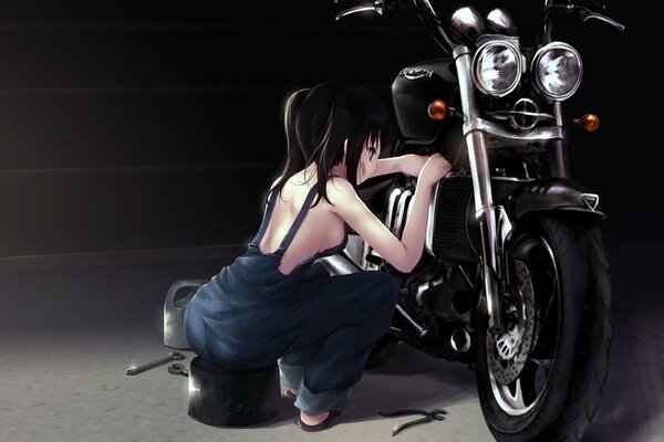 A beautiful girl repairs a motorcycle