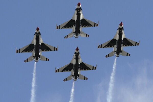 A squadron of four jet aircraft