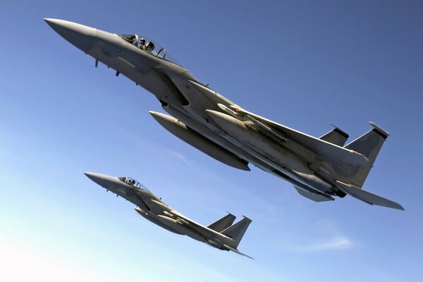Fighter jets fly in the blue sky