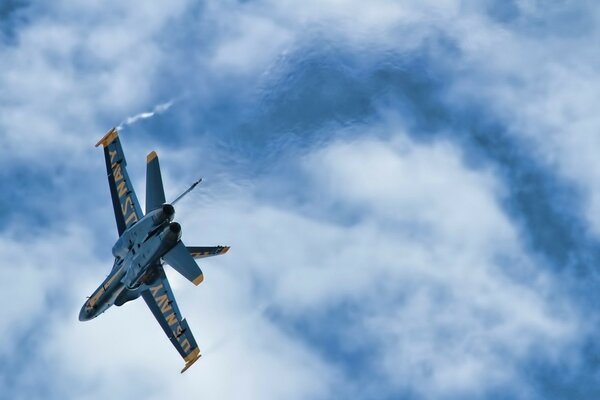 Blue fighter plane in the sky with clouds