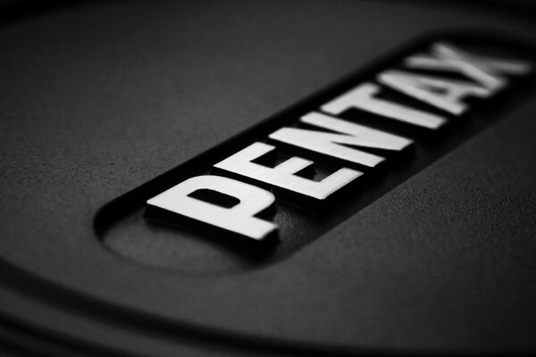 Black and white photo of the Pentax brand