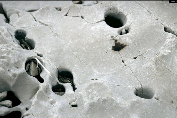 Grey stone with cracks and holes