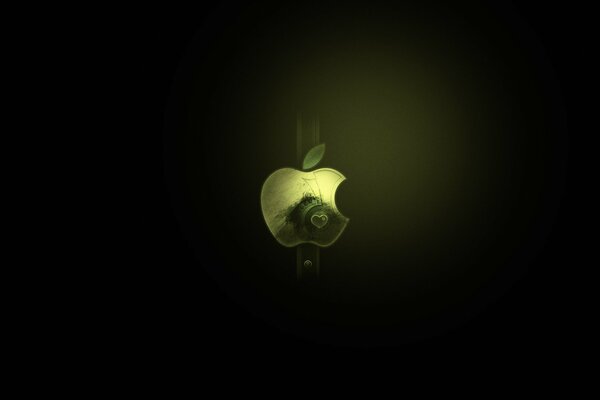 A green bitten apple on a black background