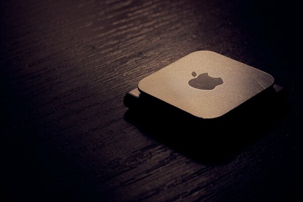 Macro photo of the apple logo in dark colors