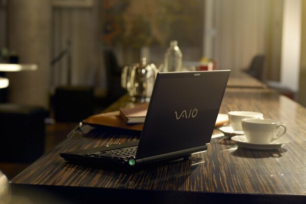 A black laptop on a dark table