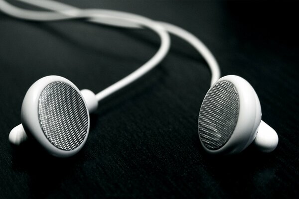 White wired headphones on a black background