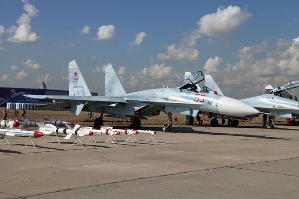 In the photo, the fighters are standing on the runway