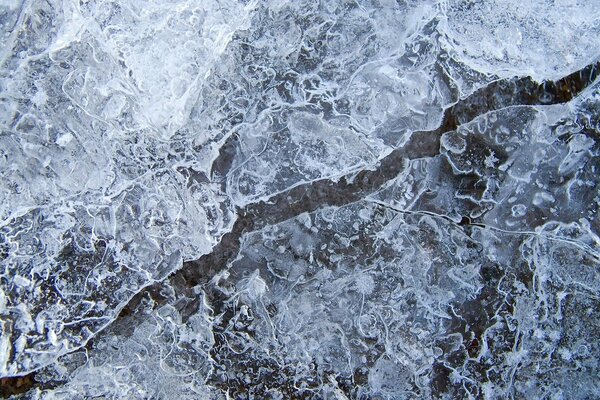 Cracked thin ice and water droplets