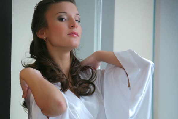 Brunette girl in a white coat