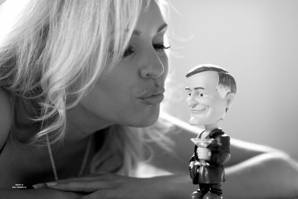 Black and white shot of a blonde with a toy