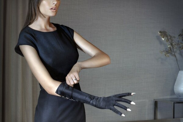 Stylish model wears a glove with holes for long nails