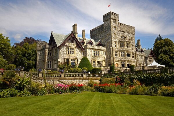 A majestic castle with a green lawn