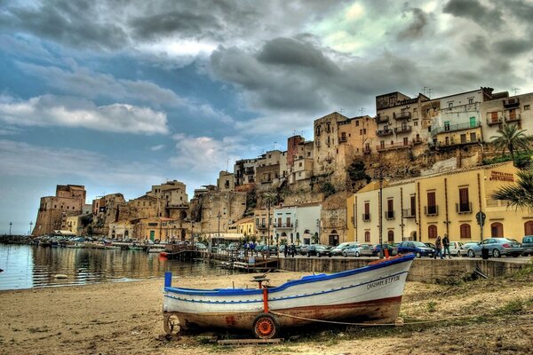 Boat on the shore of the picturesque Sicilian harbor
