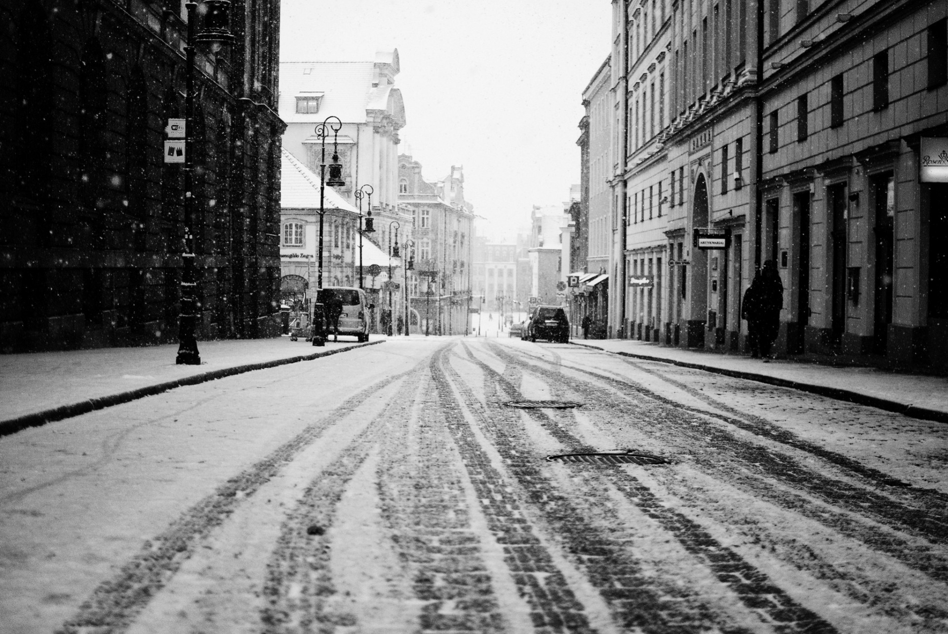 traces street building town road snow people machinery winter house