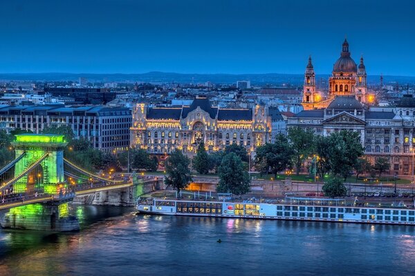 Emerald lights on the river embankment