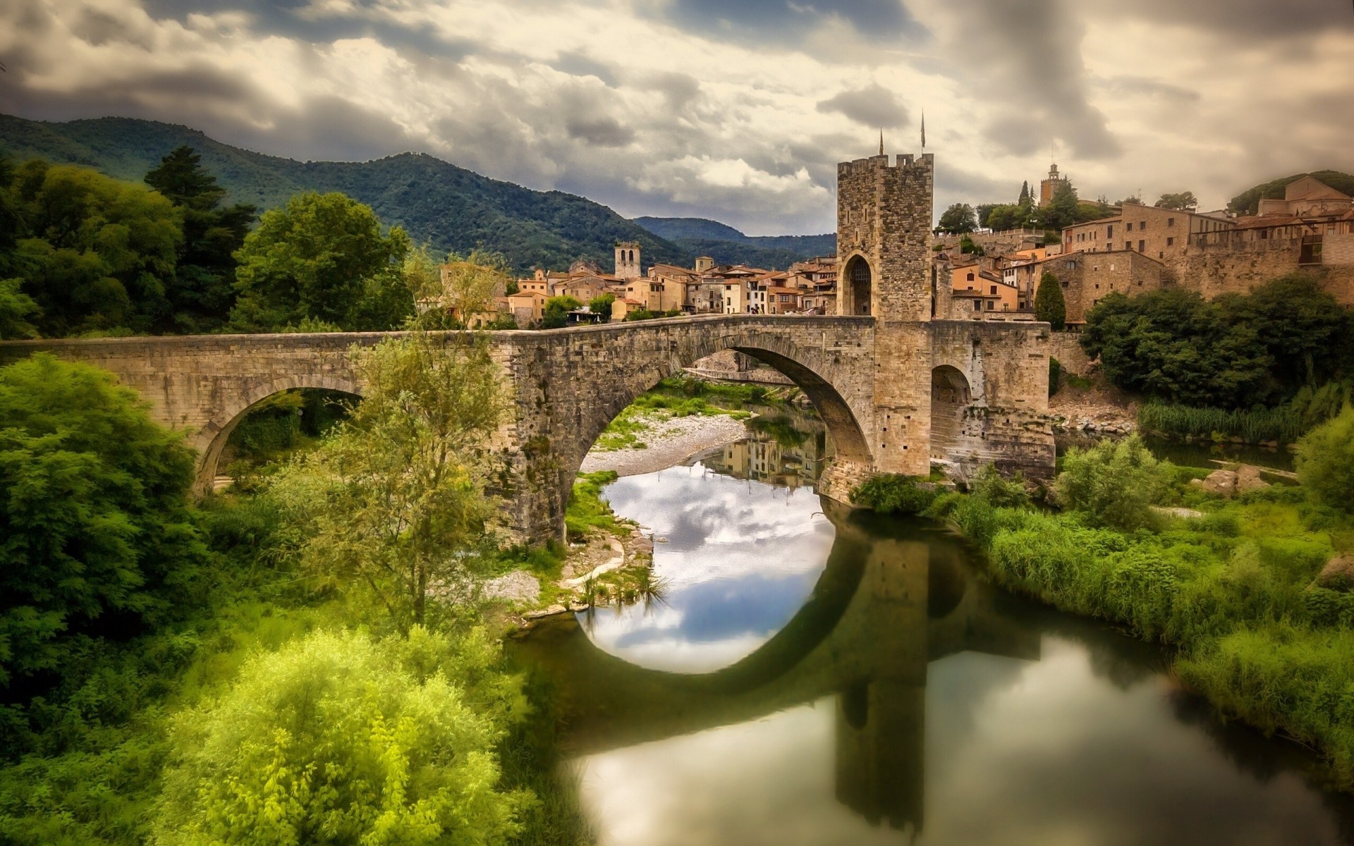 catalonia river reflection bridge besalu river fluvia spain