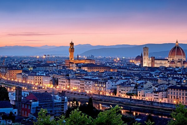 Panorama of Florence in bright lights against the sunset sky