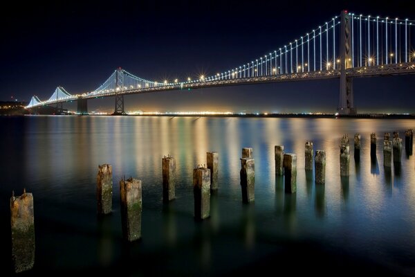 San Francisco, at night the lights near the bridge burn beautifully