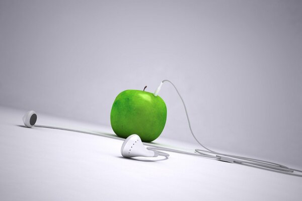 Green apple with white headphones
