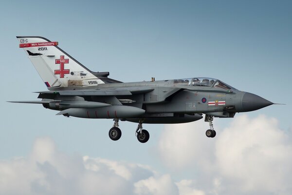 A fighter-bomber flies during the day in good weather