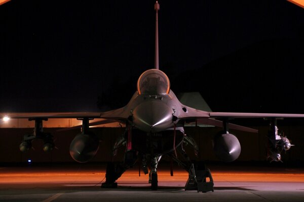 Combat fighter at the airfield in the evening