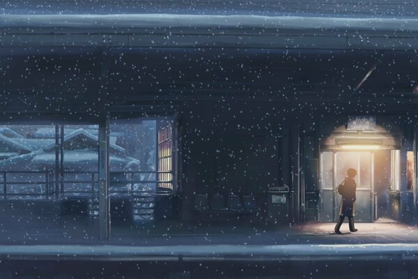 A lonely man walks down a snowy night street