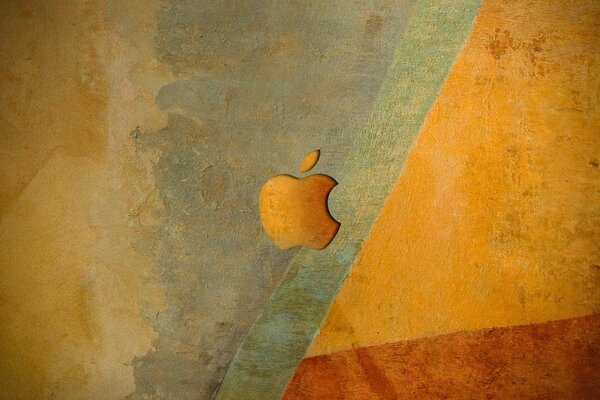 Emblema apple di tonalità arancioni sullo sfondo del muro