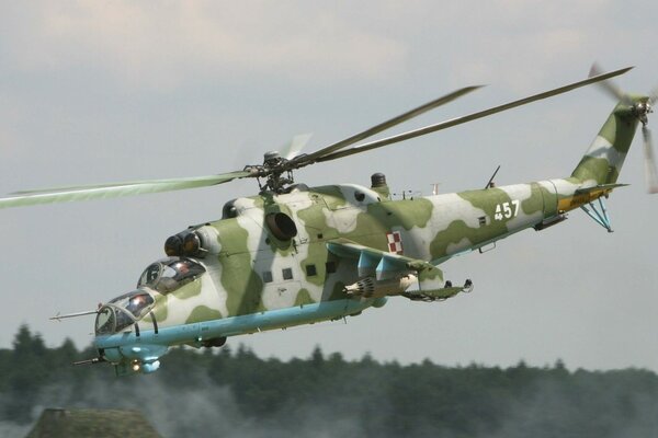 Mi24 camouflage helicopter over the forest