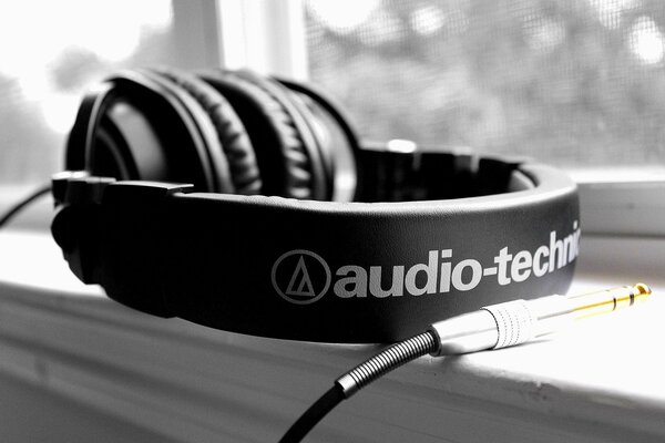 Large headphones and a plug on the windowsill