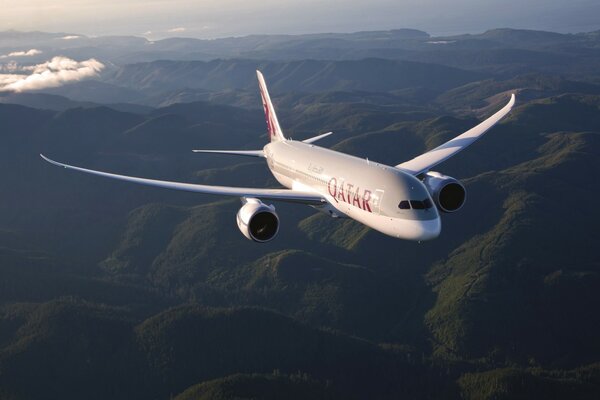 We are flying above the mountains, there is a good view from the window