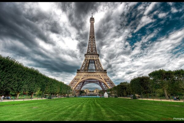 The Eiffel Tower. Green grass and clouds