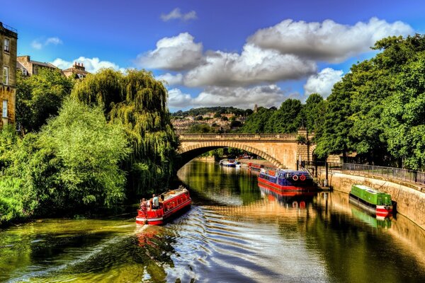 Bright boats on the background of the bridge