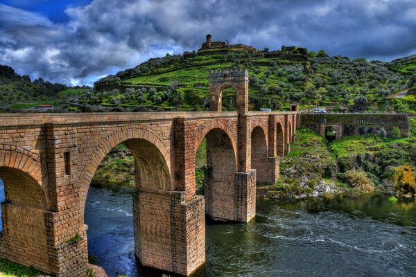 Brick bridge across the river in bright colors