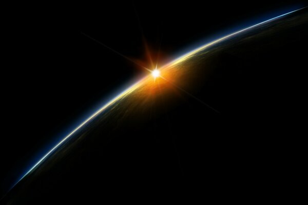 Восход солнца на краю планеты вид из глубины космоса