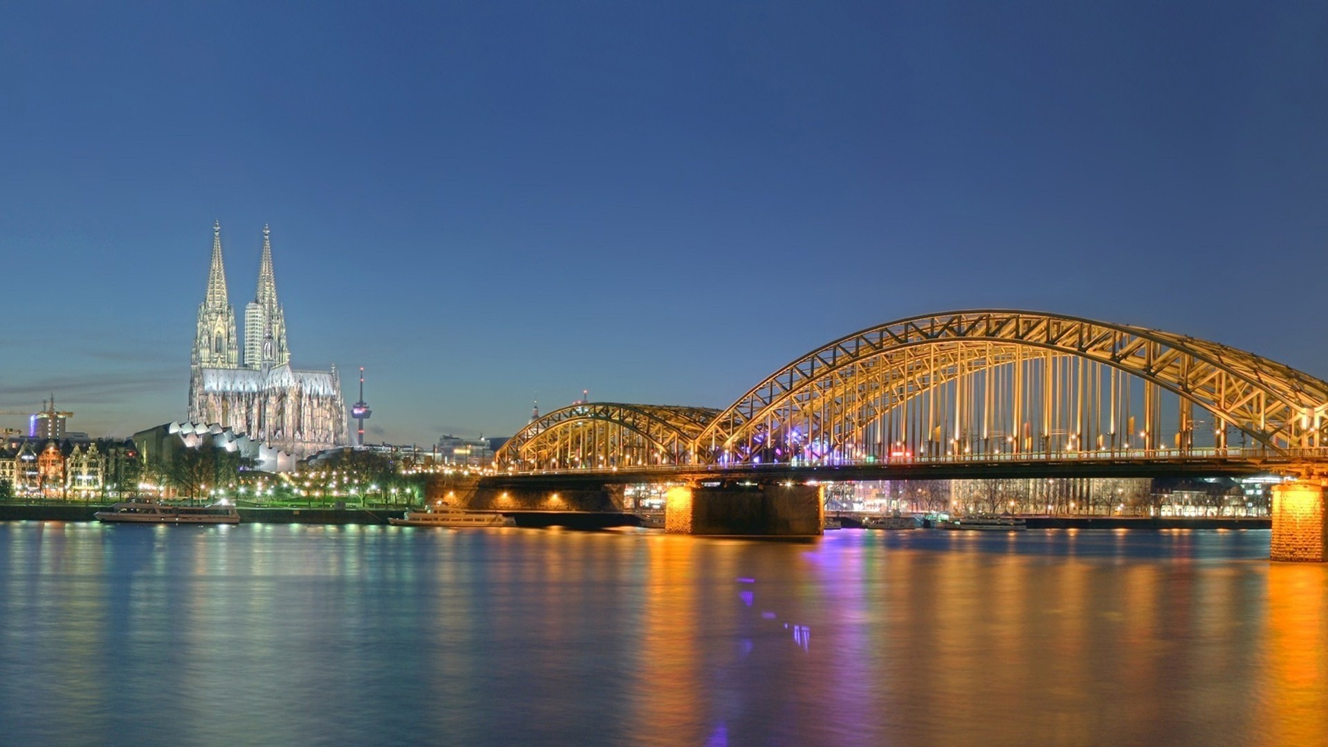 lights cathedral night river bridge town germany