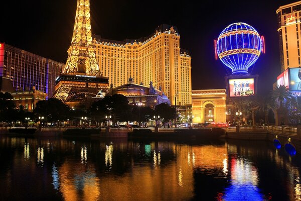 The night city is reflected in the water