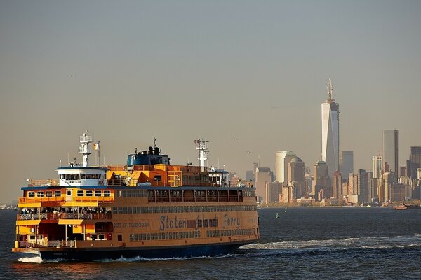 A cruise ship is sailing along the Manhattan bay