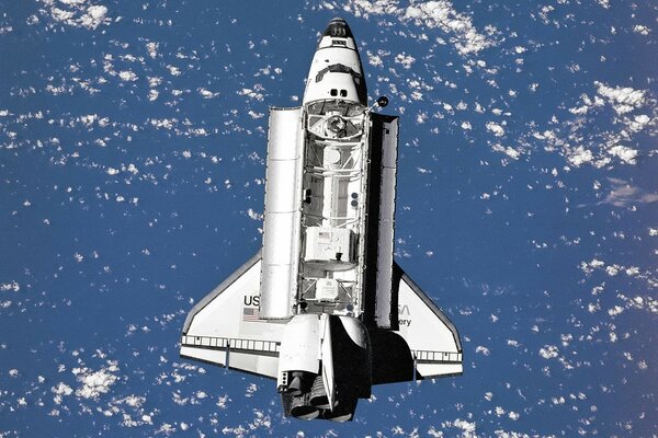 Space shuttle in flight over the earth