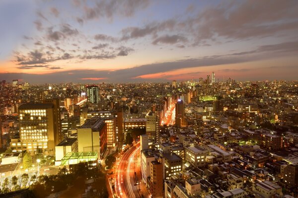 A skyscraper in a megalopolis in lights