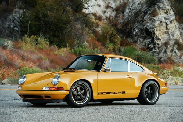 Yellow Porsche targa on the road